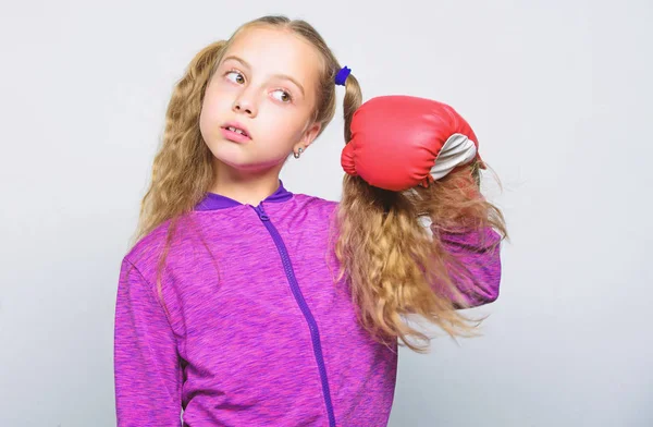 Skill of successful leader. Girl cute child with red gloves posing on white background. Sport upbringing for leader. Cute kid with sport boxing gloves. Boxing sport for female. Sport upbringing