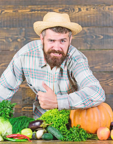 Autumn on the farm. man chef with rich autumn crop. organic and natural food. happy halloween. bearded mature farmer. seasonal vitamin food. Useful fruit and vegetable. harvest festival