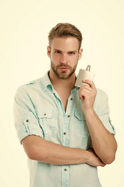 Man confident face hold perfume bottle. He likes this fragrance. Male fragrance concept. Man handsome choose pleasant fragrance for male. Everything need to know about cologne and other fragrances