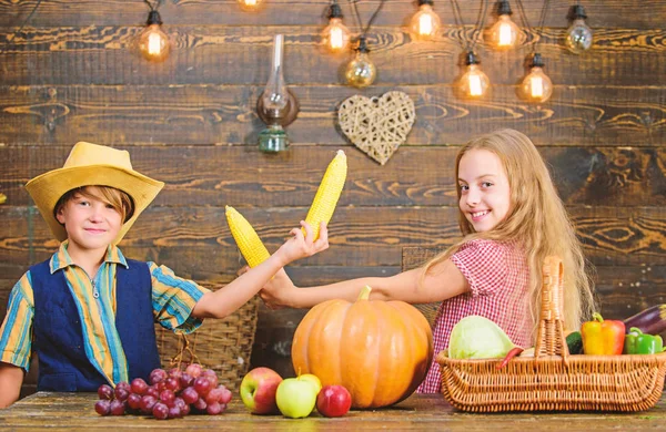 Reasons why every child should experience farming. Held responsible for daily farm chores. Kids farmers girl boy vegetables harvest. Children presenting farm harvest wooden background. Family farm