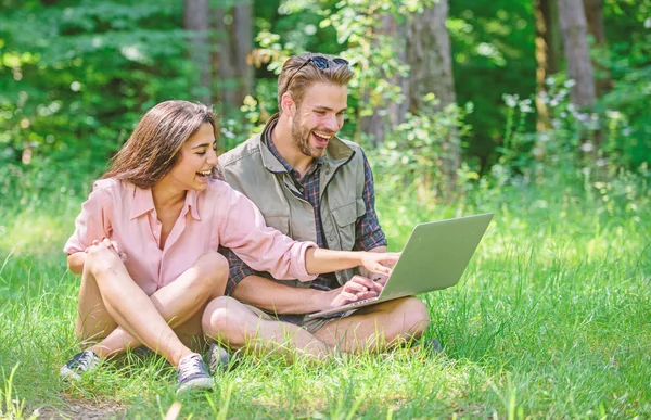 Modern technologies give opportunity to be online and work in any environment conditions. Man and girl looking at laptop screen. Freelance opportunity. Couple youth spend leisure outdoors with laptop