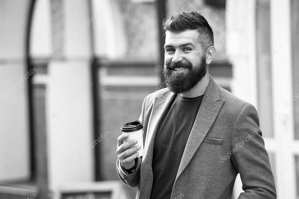 Drink it on the go. Man bearded hipster prefer coffee take away. Businessman drink coffee outdoors. Reloading energy. Relaxing coffee break. Hipster hold paper coffee cup and enjoy urban environment
