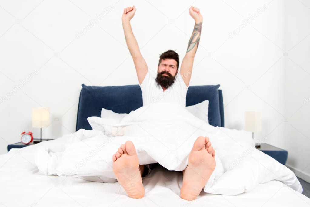 Carefree day at home. brutal sleepy man in bedroom. asleep and awake. Good morning. male with beard in pajama on bed. energy and tiredness. What a great morning. bearded man hipster sleep in morning