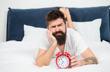Hipster sakallı adam çalar saatle yatakta yatıyordu. Uyanma zamanı. Neden her sabah erken kalkmalısın? Erken yükselen sağlık yararları. Erken uyanmak hazırlanmak ve zamanında olmak için daha fazla zaman verir