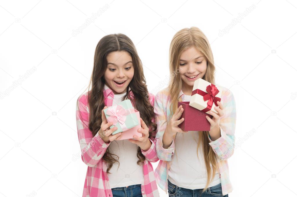 Intriguing moment. Birthday present. Girls sisters or friends hold gift boxes. Small girls open holiday present. Children excited cheerful faces hold presents. Opening gifts. Perfect present for teen