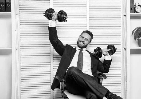 Good job concept. Boss businessman office manager raise hands with dumbbells. Boost business. Boost your managing skill. Man bearded guy raise heavy dumbbells. Boost sales with strong strategy
