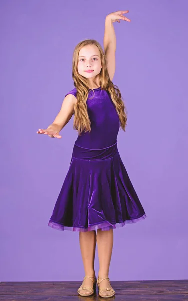 a cute little girl in comfortable clothes is dancing Stock Photo