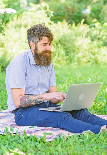 Blogger create content for social network. Writer or blogger write post for social network. Inspiration for blogging. Blogger becoming inspired by nature. Man bearded with laptop nature background