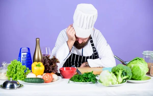 Healthy food for success. Dieting with organic food. Fresh vegetables. Healthy food and vegetarian. Professional chef in uniform. Vitamin. man use kitchenware. tired bearded man cooking in kitchen — Stock Photo, Image