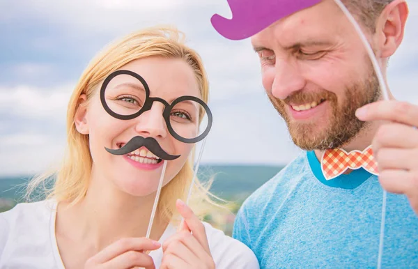 Just for fun. Humor and laugh concept. Couple posing with party props sky background. Photo booth props. Man with beard and woman having fun party. Add some fun. Making funny photos birthday party