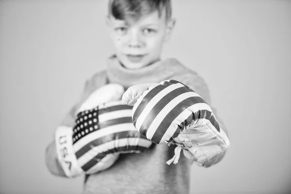 Boxing sport. Ready for sparring. Confident in his strength. Start boxing career. Boy sportsman wear boxing gloves with usa flag. American boxer concept. Child sporty athlete practicing boxing skills