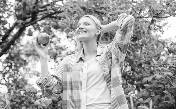 vitamin and dieting food. orchard, gardener girl in apple garden. Happy woman eating apple. healthy teeth. hunger. spring harvest. summer fruit. picnic in the countryside. healthcare and diet