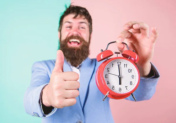 Businessman finished on time. Time management skills. Best time of day. Just in time. Man bearded happy cheerful businessman hold alarm clock. Timely concept. Hipster happy working day is over