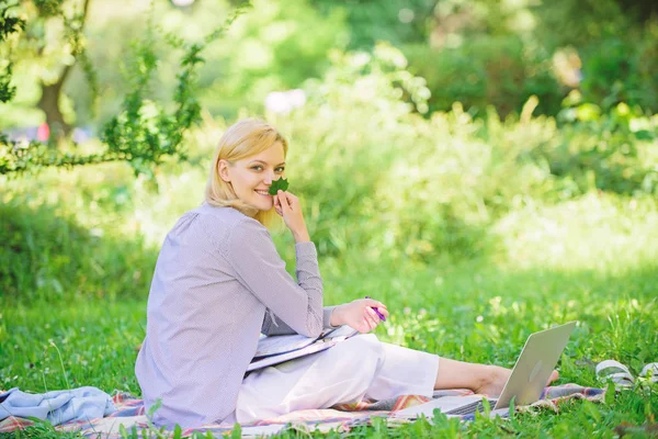 Managing business remote outdoors. Woman with laptop sit grass meadow. Best jobs to work remotely. Business lady freelance work outdoors. Remote job concept. Stay free with remote job