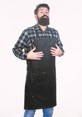 İş bağımlılığı. Hippi, berber dükkanında ya da mutfakta rutin işlere hazırlanıyor. Birden fazla cepli iş önlüğü giyen sakallı bir adam. İş bağımlısı. Rutin çalışma faaliyetleri