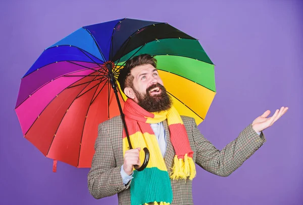 Looking like its going to rain. Autism. Autistic rain man holding colorful umbrella. Bearded man checking if it rains. Fashion man with colorful accessories. He never needs to worry about rainy days