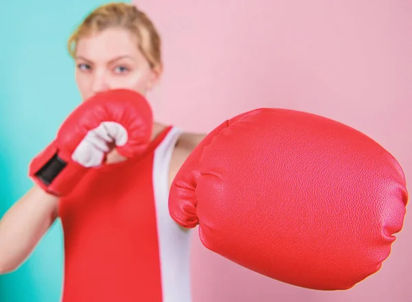 Ambitious girl fight boxing gloves. Female rights. I am gonna kick you off. Confident in her boxing skill. Boxing improve temper and will. Concentrated on punch. Woman boxing gloves focused on attack