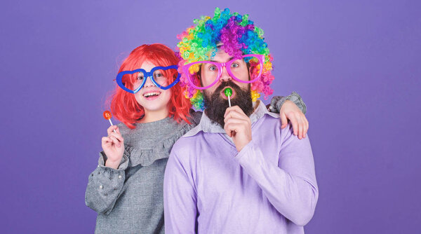 Easy simple ways be fun playful parent. Man bearded father and girl wear colorful wig while eat lollipop candy. Thing loving father do for children. Tribute to fun dad. How crazy is your father