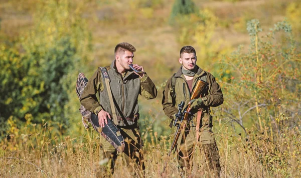 Hunters gamekeepers looking for animal or bird. Illegal hunting. Hunters friends enjoy leisure. Hunters with rifles in nature environment. Poacher partner in crime. Activity for real men concept — Stock Photo, Image