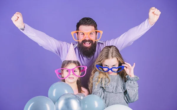 Pleasure cannot wait. Happy family with two children. Family of father and daughters wearing fancy glasses. Father and girl children enjoying party. Happy family celebrating. Family day celebration