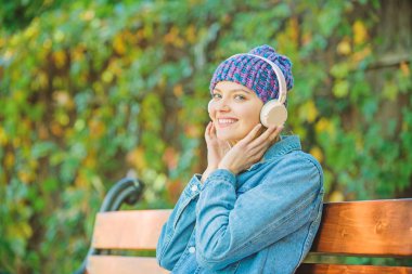 parkta müzik dinleme. parkta dinlenebilirsiniz. MP3 çalar ile hipster kız. modern teknoloji yerine okuma. Kulaklıkta hipster kadın. sesli kitap. stil ve müzik. En sevdiği müziğin tadını çıkarmak