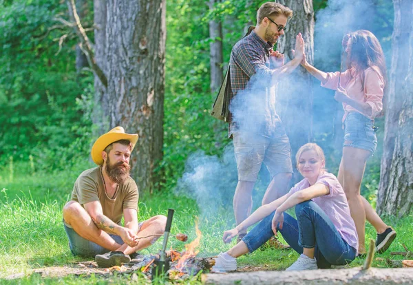 Join summer picnic. Friends meeting near bonfire to hang out and prepare roasted sausages snacks nature background. Company having fun while roasting sausages on sticks. Gathering for great picnic