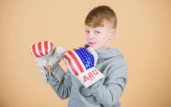 punching knockout. Fitness diet. energy health. Sport success. sportswear fashion. usa independence day. Happy child sportsman in boxing gloves. workout of small boy boxer. Feeling free and confident