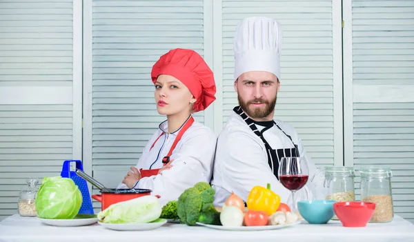 Cooking with your spouse can strengthen relationships. Woman and bearded man culinary partners. Ultimate cooking challenge. Reasons why couples cooking together. Couple compete in culinary arts