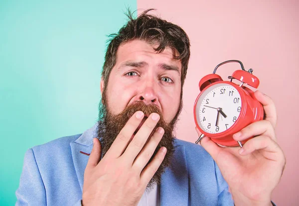 Time management skills. How much time till deadline. Time to work. Man bearded sleepy tired businessman hold clock. Stress concept. Hipster stressful working schedule. Businessman has lack of time