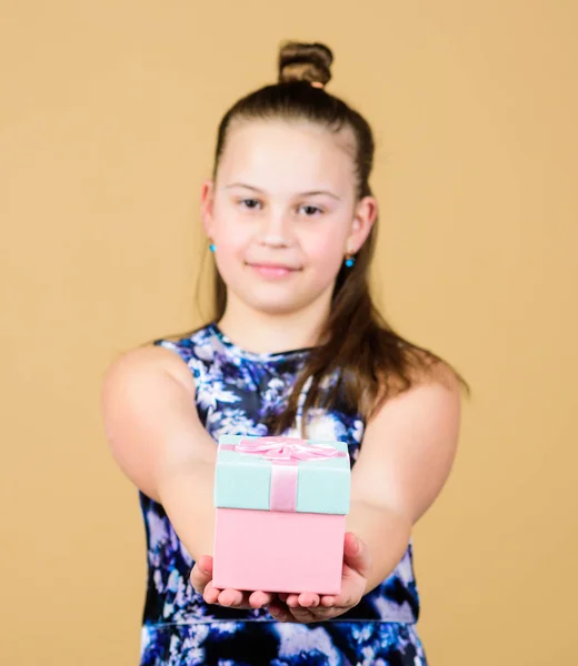 Thank you so much. Child hold gift box beige background. Kid girl delighted gift. Girl adorable celebrate birthday. Kid happy loves birthday gifts. Shopping and holidays. Share and generosity