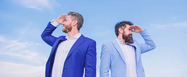Changing course. Men formal suit managers looking at opposite directions. New business directions. Developing business direction. Businessmen bearded faces stand back to back sky background — ストック写真