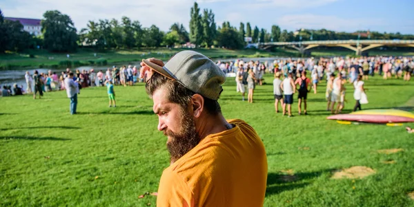 Guy celebrate holiday or festival. Summer fest. Man bearded hipster in front of crowd. Book ticket now. Open air concert. City day. Music festival. Entertainment concept. Visit summer festival