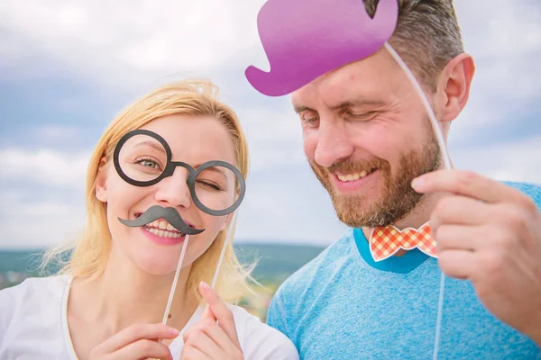 Humor and laugh concept. Couple posing with party props sky background. Photo booth props. Man with beard and woman having fun party. Add some fun. Making funny photos birthday party. Just for fun