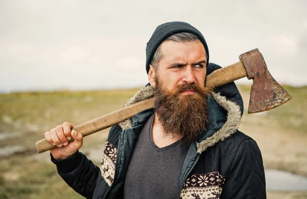 Lumberjack in the woods with an ax.