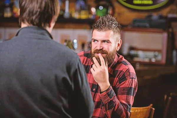 Friends relaxing in bar or pub. Interesting conversation. Hipster brutal bearded man spend leisure with friend at bar counter. Men relaxing at bar. Friendship and leisure. Friday relaxation in bar — Stock Photo, Image