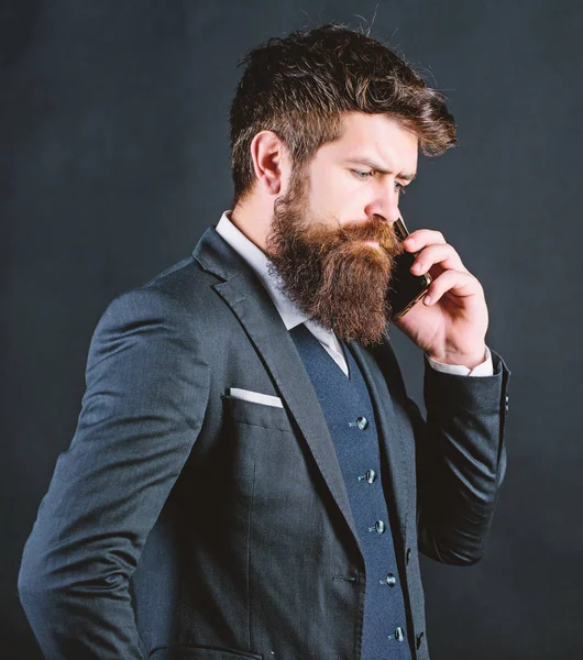 Guy call friend stand black background. Mobile call concept. Man formal suit call someone. Mobile call conversation. Mobile negotiations. Businessman well groomed mature man hold smartphone