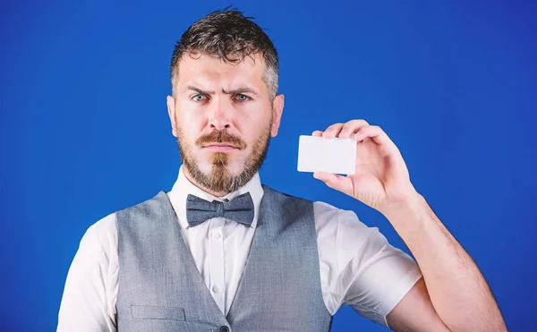 A small detail can make a big difference. Hipster with credit card. Bearded man holding business card. Businessman with bank card. Empty card for your contact information, copy space