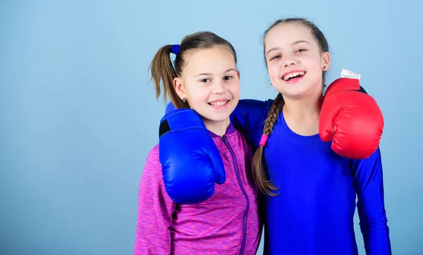 Girls in boxing sport. Boxer children in boxing gloves. Confident teens. Female boxers. Boxing provide strict discipline. Girls cute boxers on blue background. Competitors on ring and friends in life
