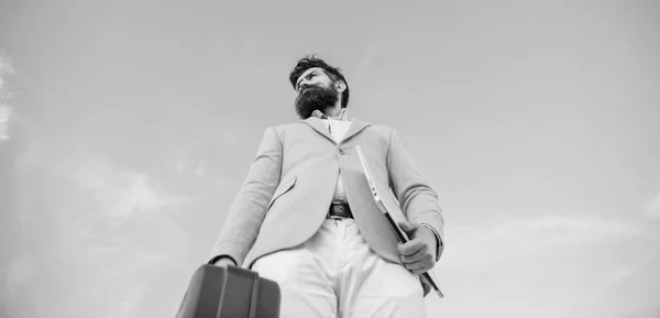 Businessman presenting business case. Business man formal suit carries briefcase sky background. Entrepreneur offer bribe. Hipster bearded face hold briefcase with bribe. Illegal deal business