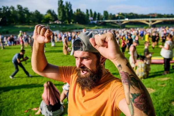 Victory. Bearded man celebrating victory on summer nature. Happy hipster celebrating and making winner gesture. Enjoy celebrating a holiday or the occasion