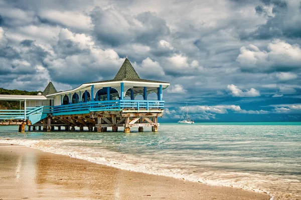 Sea bungalow holidays. Sea turquoise water and bungalow house. Vacation sea sand beach tropical house bungalow st.johns antigua stormy day. Dramatic cloudy sky at seaside. Vacation on islands