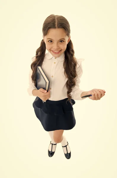 Write note to remember. Child school uniform smart kid happy make note. Child girl happy school uniform clothes holds book ready write note. Girl happy face make note about idea white background — Stock Photo, Image