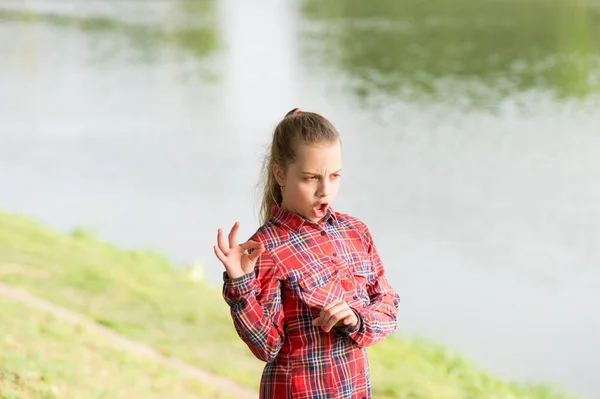 Calm and peaceful. Life balance. Peaceful mood. Girl little cute child enjoy peace and tranquility at riverside. Place of power. Peaceful place. River clears the mind. Find peace and relax in nature