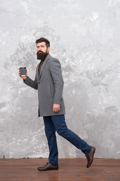 trendy man with beard. Brutal bearded hipster in denim wear. Casual style. Modern life. Male fashion model. Mature businessman drink coffee on go. Hurrying to be in time. Hurrying to office