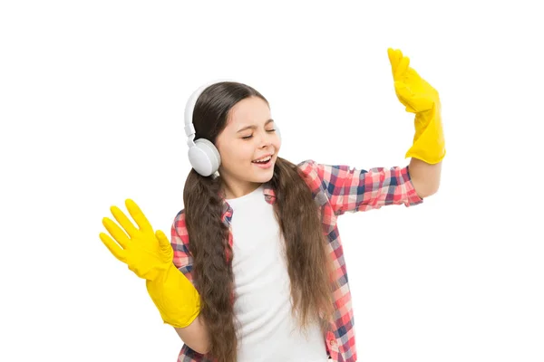 Playing music can cut cleaning time in half. Girl wear headphones and protective gloves for cleaning. Listening music and cleaning house. Having fun. Make household more joyful. Cleaning and dancing — Stock Photo, Image