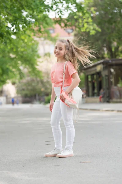 Kid long hair enjoy walking. Summer holidays. Little child enjoy walk. Health, good mood and positive energy. Energetic child. Save energy for long walk. Full of energy. Girl carefree child