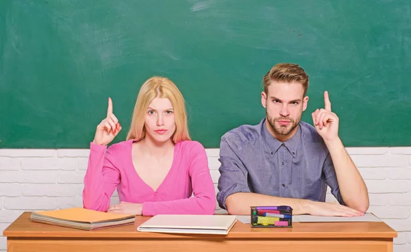 Enjoying university life. Guy and girl sit at desk in classroom. Correct answer on their mind. Studying in college or university. Apply for free program. Couple friends students studying university — Stock Photo, Image