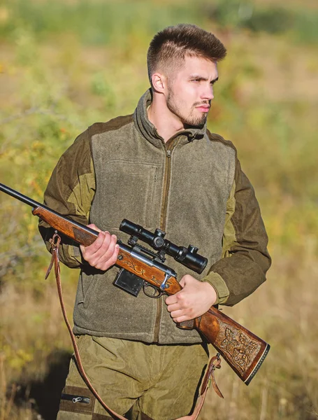 Hunting and trapping seasons. Bearded serious hunter spend leisure hunting. Man brutal unshaved gamekeeper nature background. Hunting permit. Hunter hold rifle. Hunting is brutal masculine hobby — Stock Photo, Image