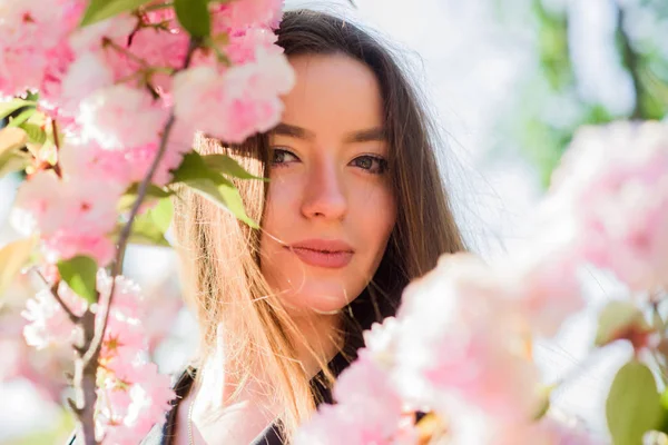 blossom smell, allergy. woman in spring flower bloom. skincare and spa. Natural cosmetics for skin. girl in cherry flower. Sakura tree blooming. natural summer beauty. Spring mood