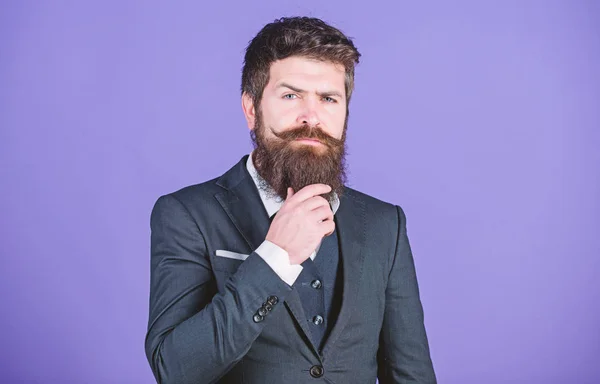 Elegancy and male style. Fashion concept. Guy wear formal outfit. Impeccable style. Businessman fashionable outfit stand violet background. Man bearded hipster wear classic suit outfit. Formal outfit